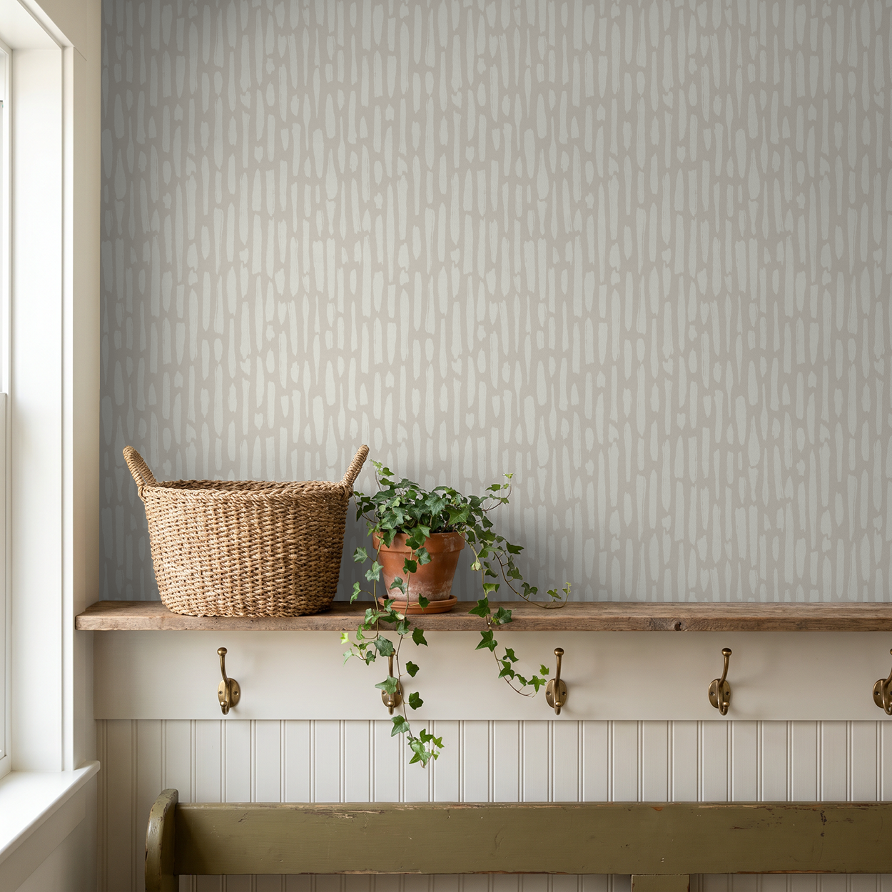 Greige brushstroke wallpaper in organic modern entryway with woven basket and wood shelf
