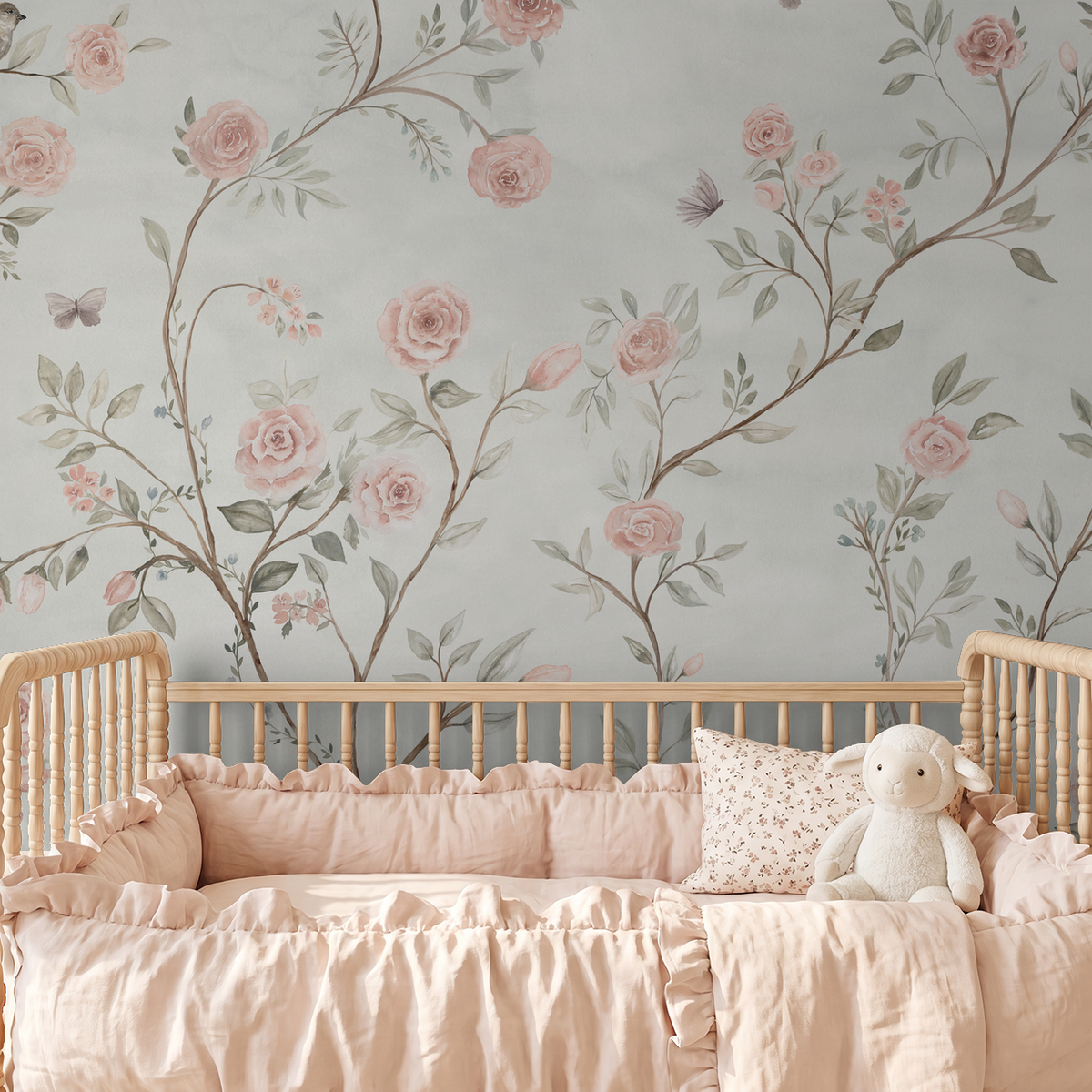 Large-scale watercolor floral wallpaper with climbing pink roses in a romantic nursery.