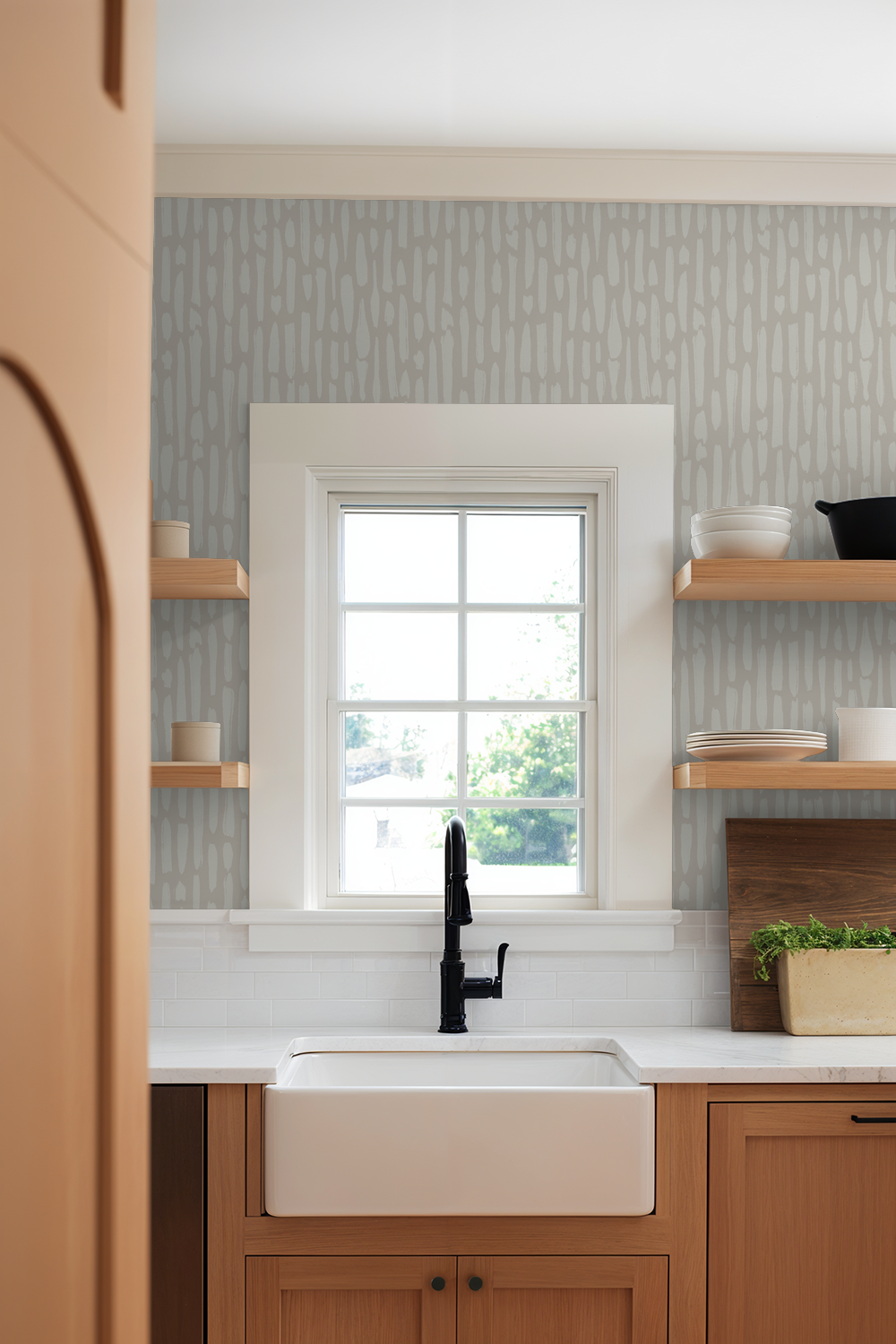 Limestone Brush greige wallpaper in modern kitchen with warm wood shelving