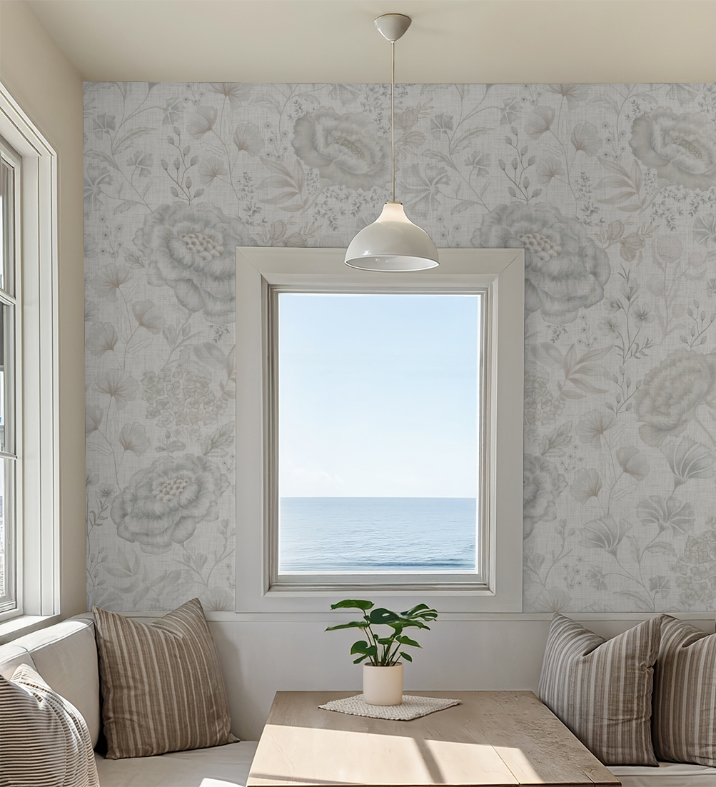 Linen floral wallpaper in soft grey and cream in a cozy dining nook with ocean view.