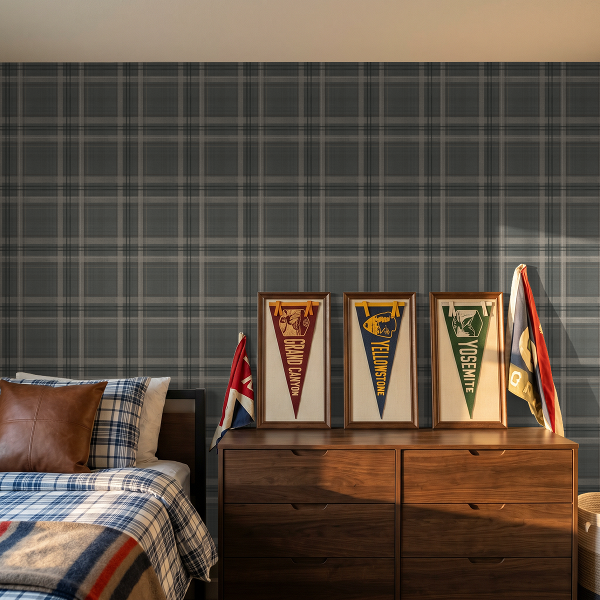 Lodge Plaid wallpaper in a boys' bedroom with vintage national park pennants, wood dresser and plaid bedding.
