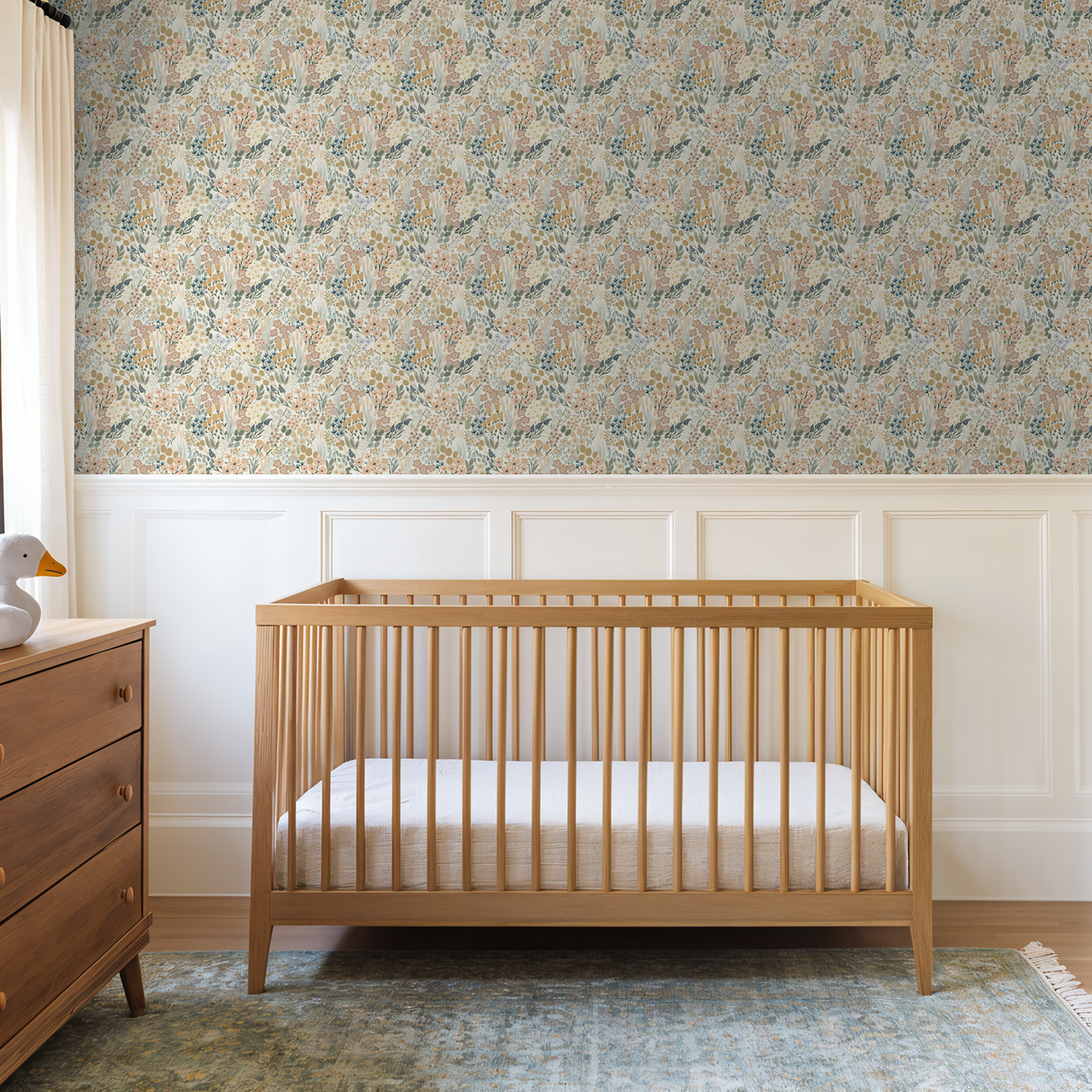Meadowlark floral wallpaper in soft sage and blush nursery with natural wood crib