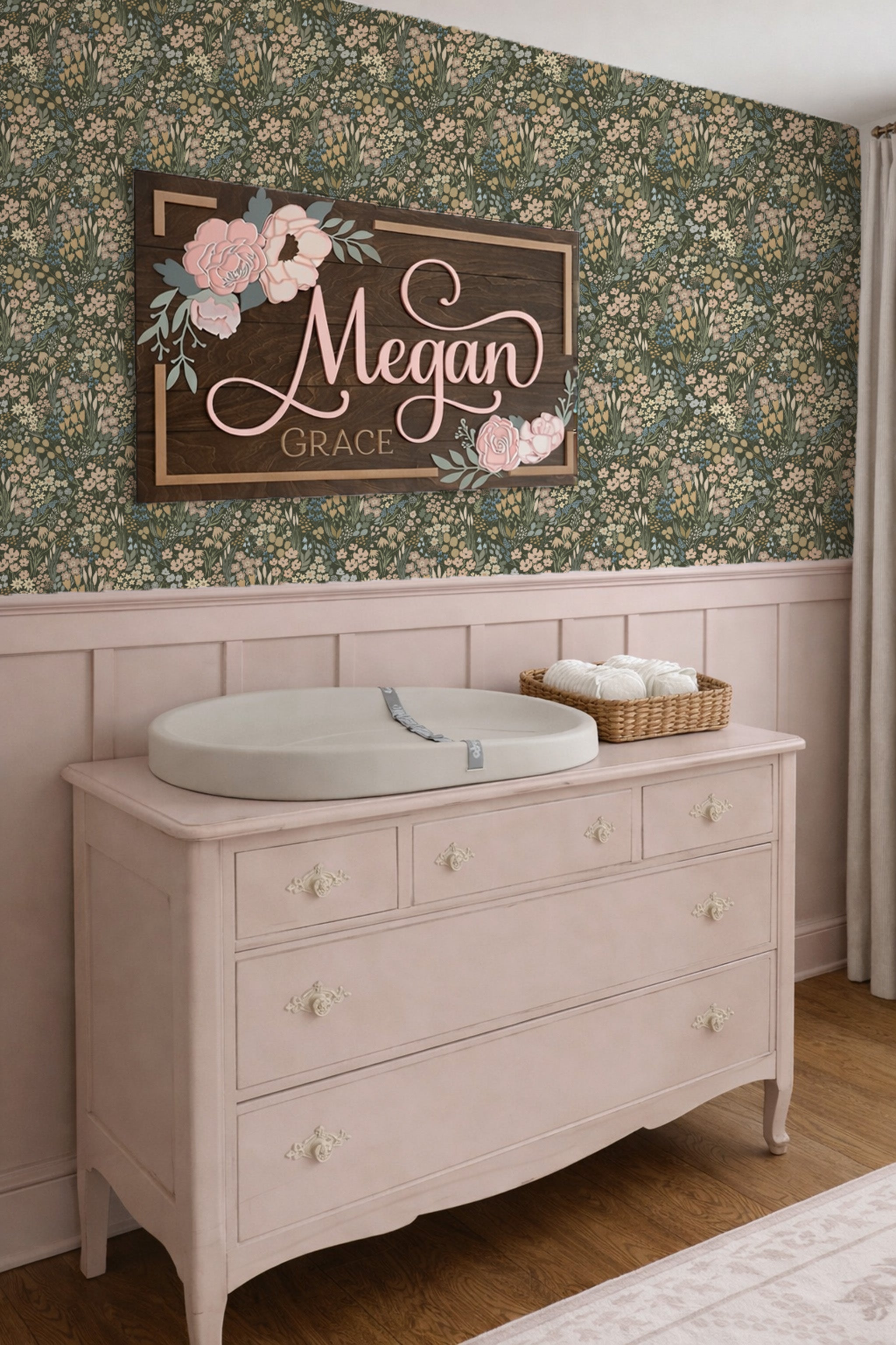 Baby changing table with Meadowlark Floral Field wallpaper above it.