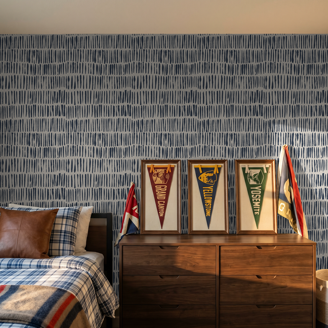 Navy abstract brushstroke wallpaper in modern bedroom with wooden dresser.