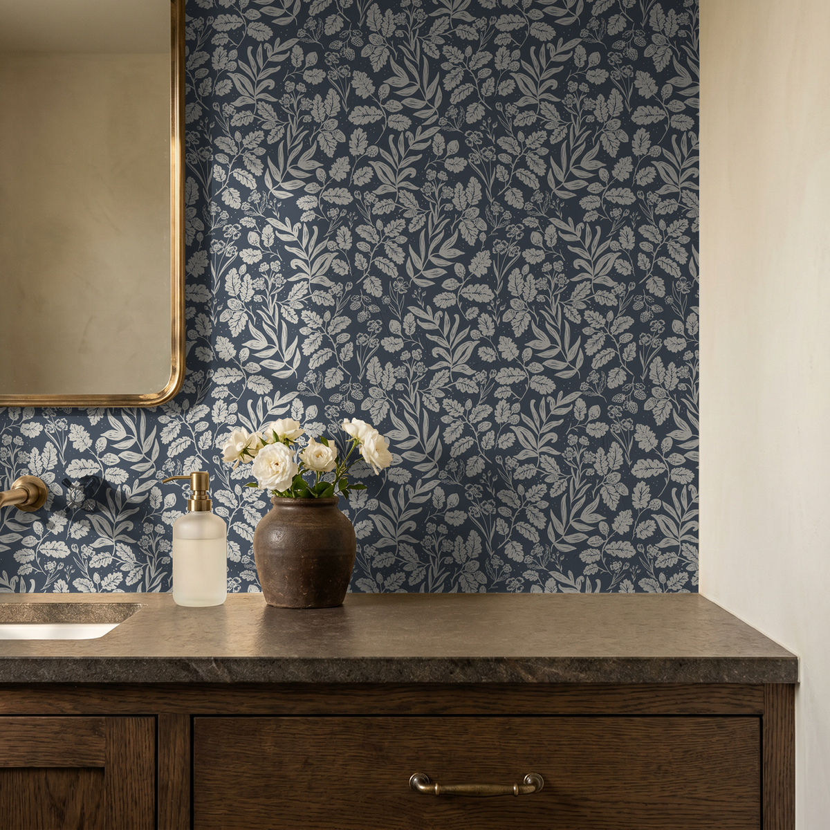 Navy botanical wallpaper with ivory oak leaves and acorns in a warm wood bathroom.