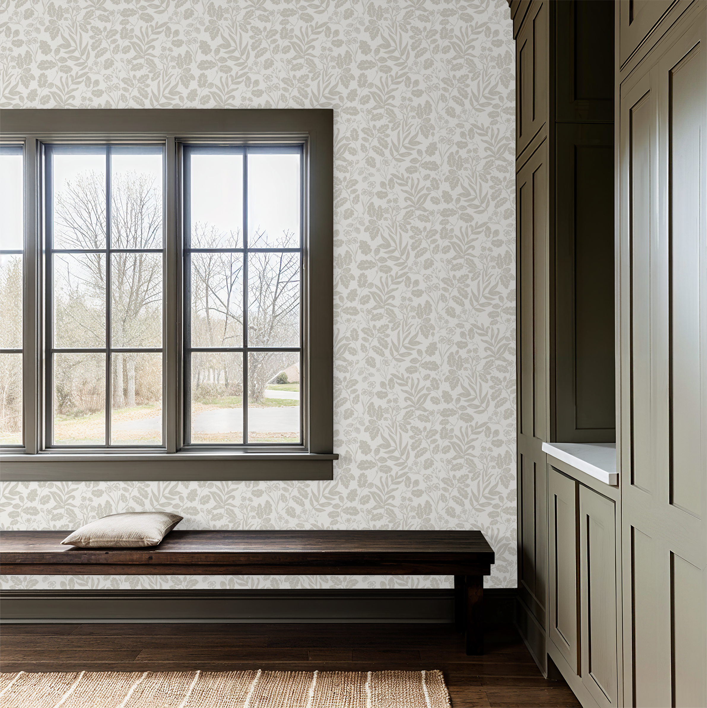 Mudroom with wooden bench, window, and patterned wallpaper