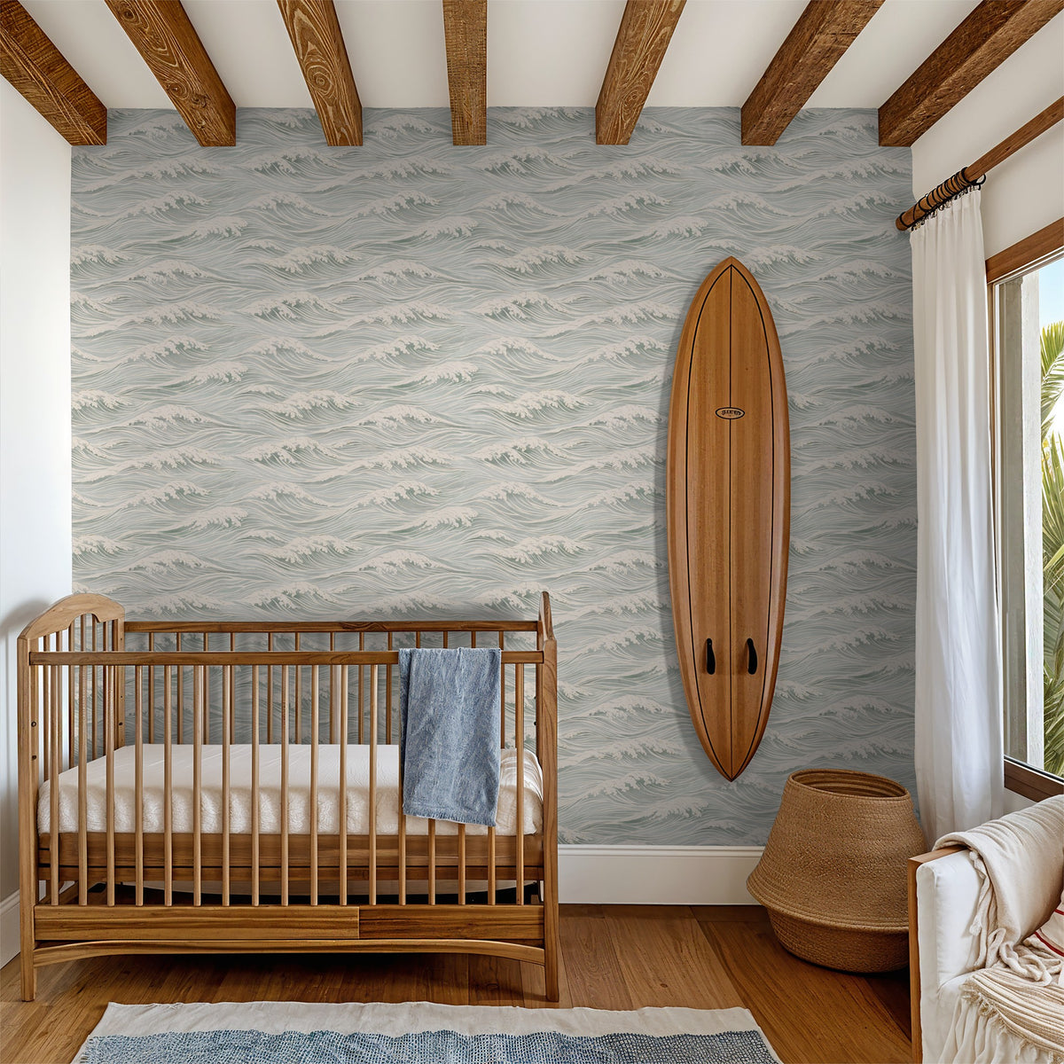 Coastal ocean wave wallpaper in a nursery with natural wood crib and vintage-style surfboard decor.
