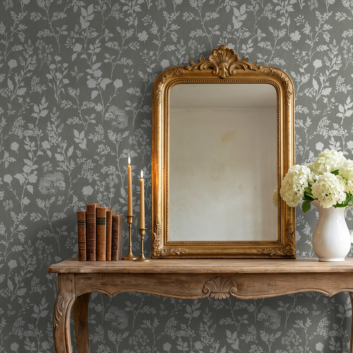 Olive floral wallpaper with white wildflowers in vintage setting with mirror and wooden table.