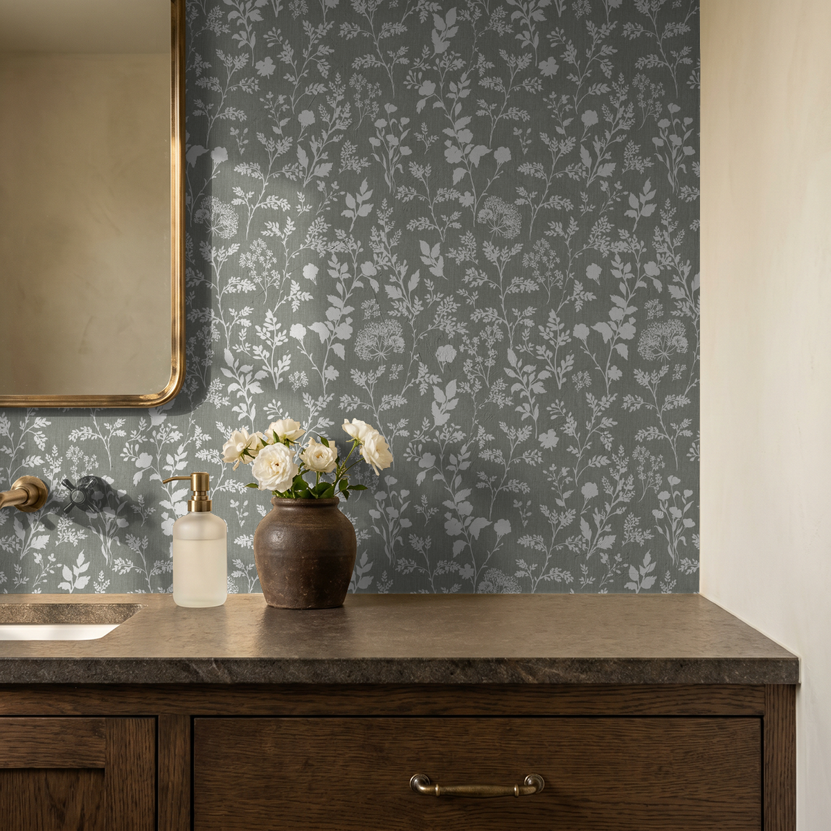 Olive floral wallpaper with white wildflowers in rustic bathroom setting.