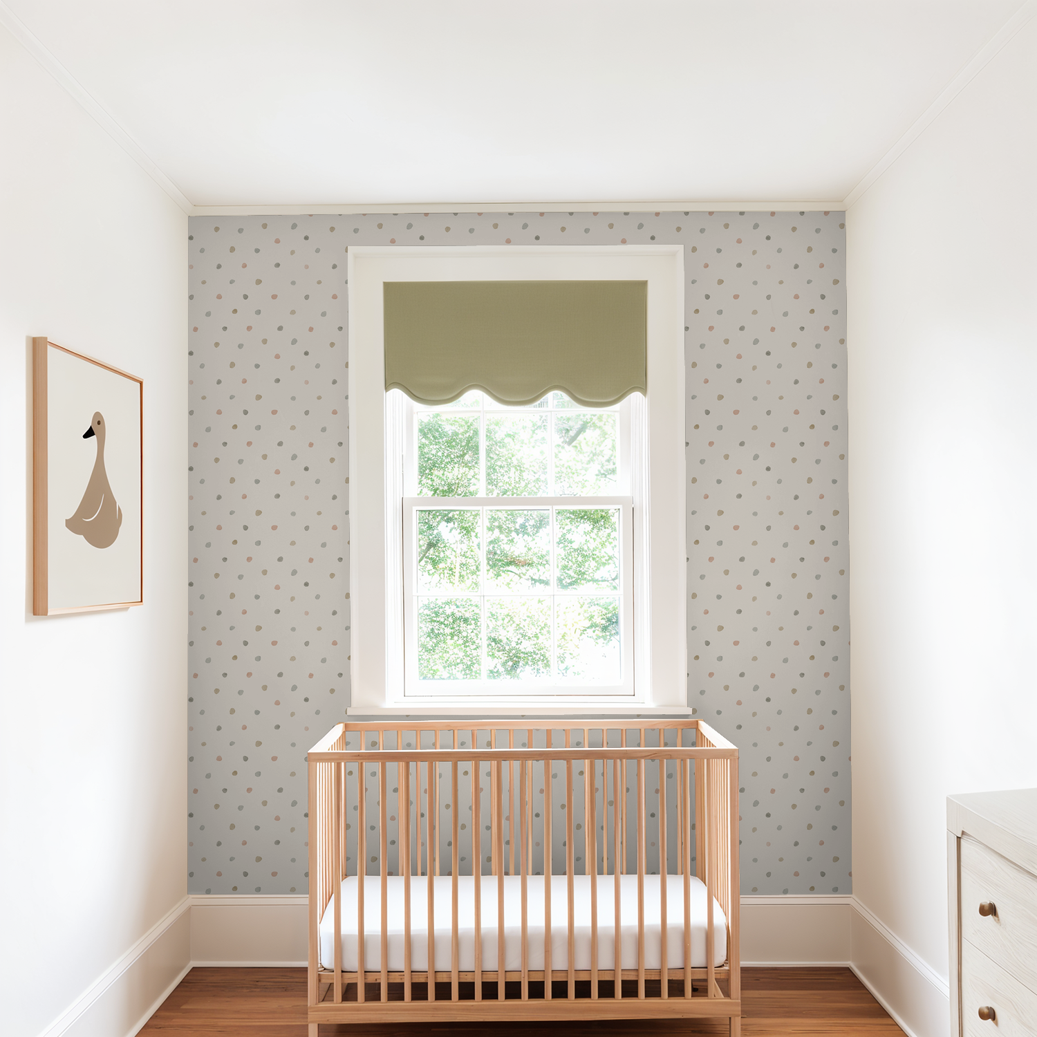 Pastel dot wallpaper in a bright nursery with crib and window.