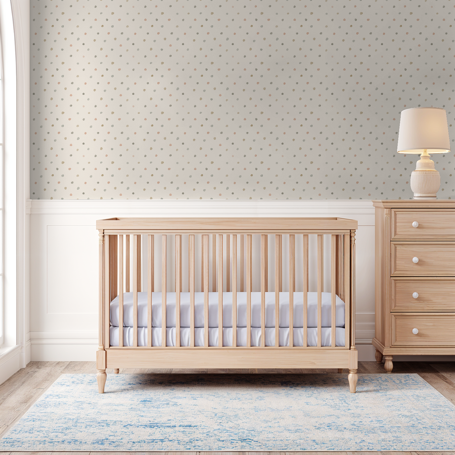 Pastel polka dot wallpaper in a cozy nursery with wooden crib and dresser.