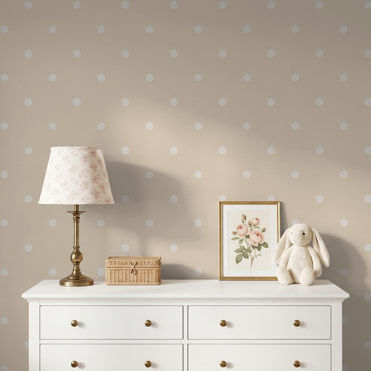 Soft peach polka dot wallpaper in cozy bedroom with white dresser and decor.