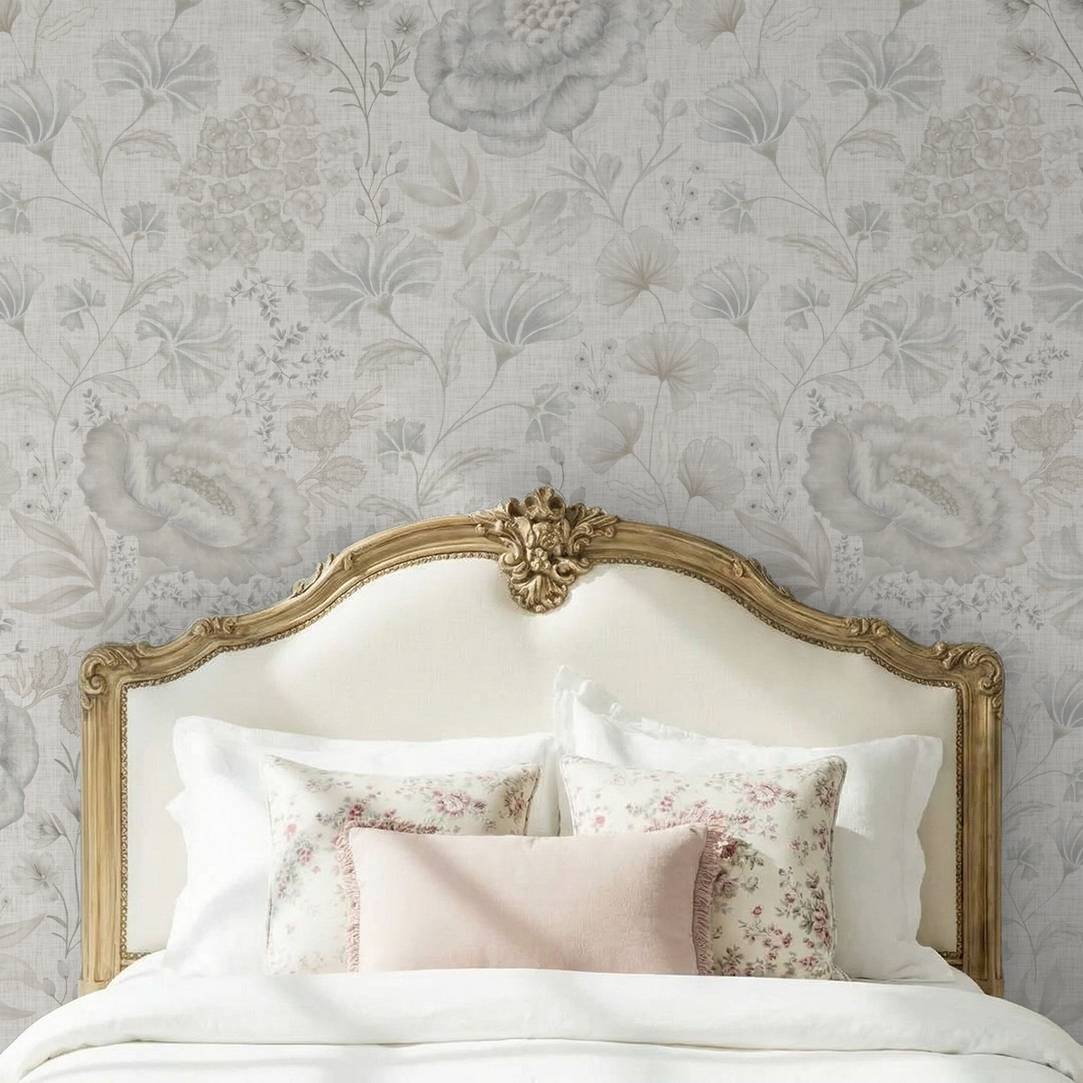 Pottery & Linen Floral wallpaper with oversized misty blue blooms behind an antique gold upholstered headboard.
