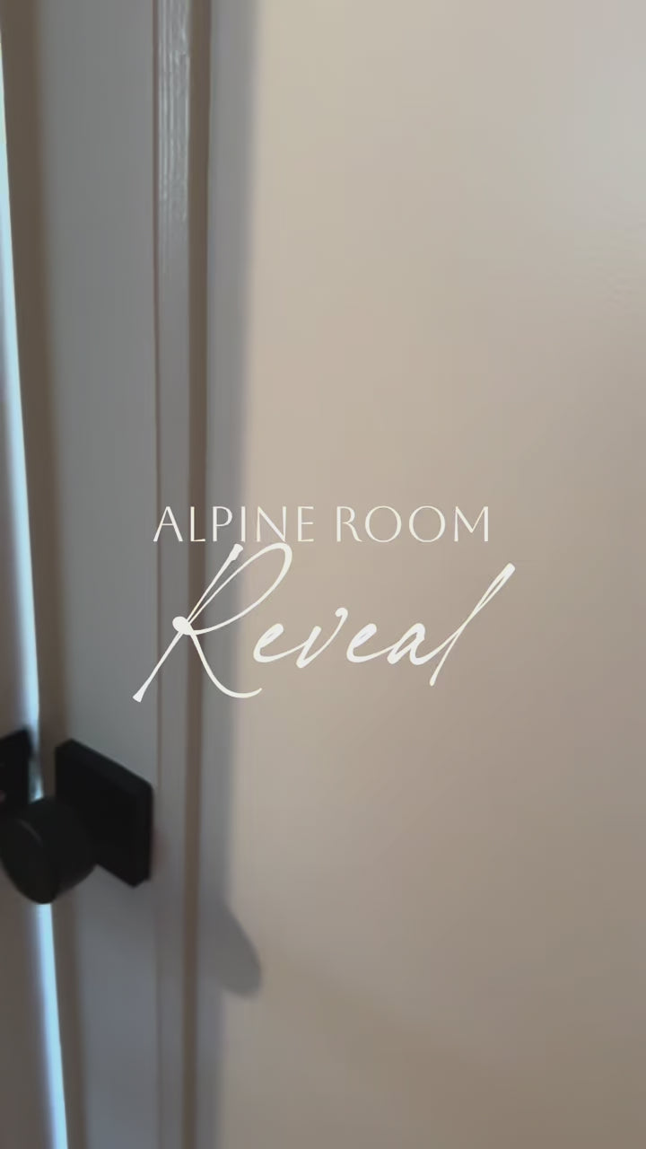 Kids’ room with twin beds featuring the alpine ski mountain mural under the eaves, paired with coordinating mountain wallpaper on the angled wall.