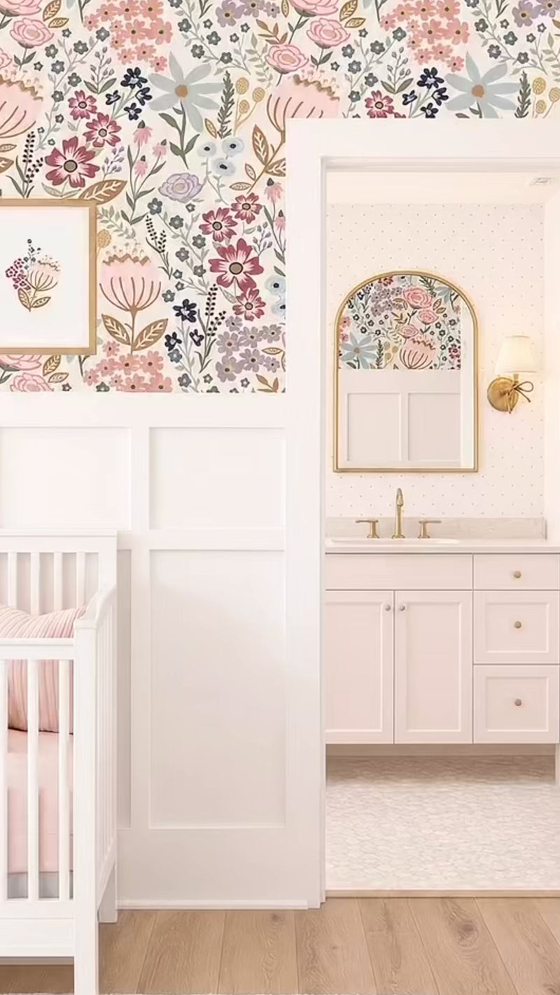 Nursery with ensuite bathroom, white millwork panelling and bright playful floral wallpaper