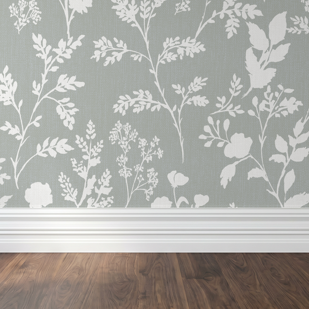 Sage botanical wallpaper with white wildflower silhouettes in a room with wood flooring.