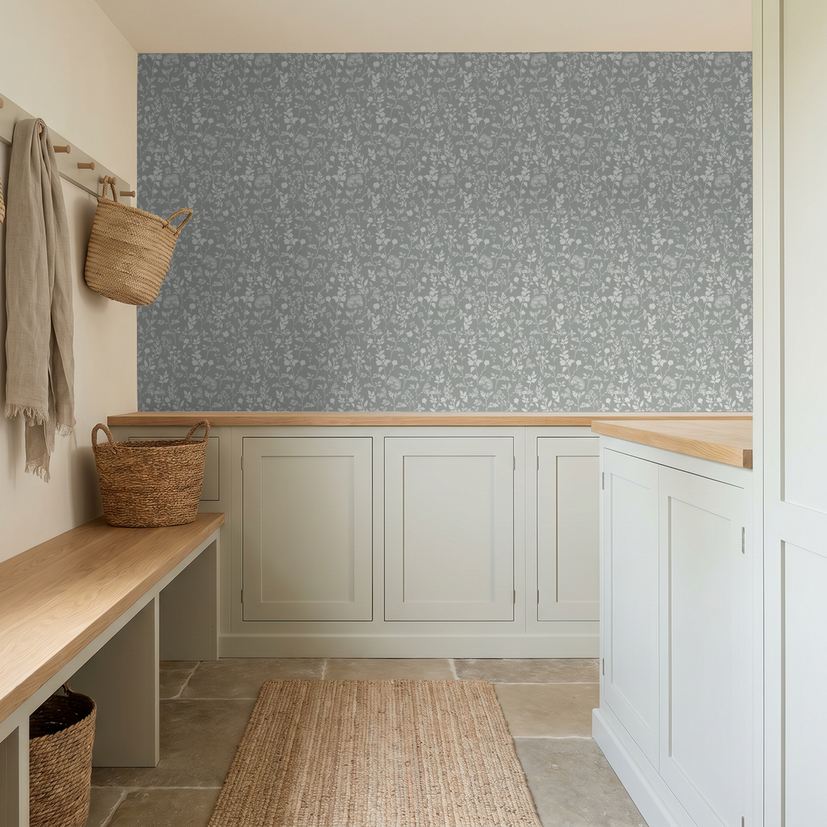 Sage wildflower botanical wallpaper in rustic mudroom with wicker baskets and wooden bench.