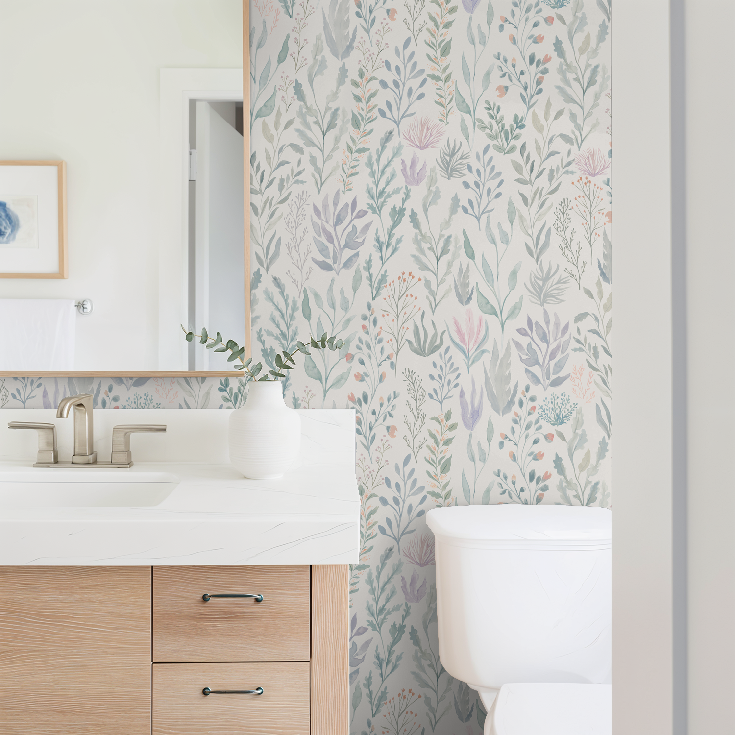 Coastal Bathroom with seafoam and lavender floral Reef Ocean wallpaper, wooden vanity, white vase.