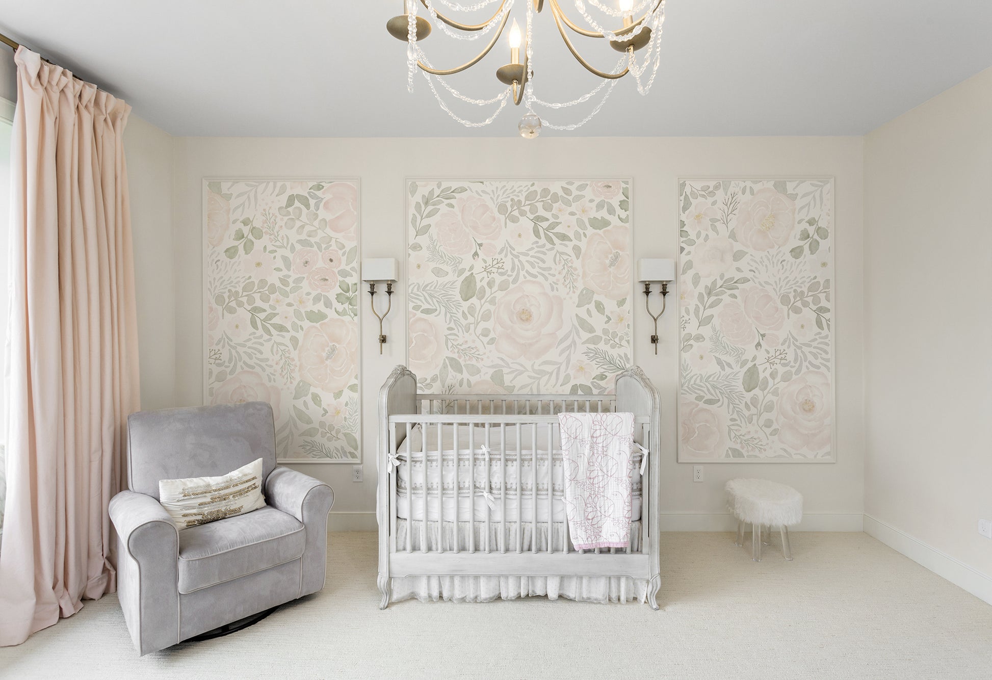 Elegant nursery with three framed mural panels of blush watercolor peonies and greenery behind a vintage-inspired crib, creating a classic, feminine feature wall.