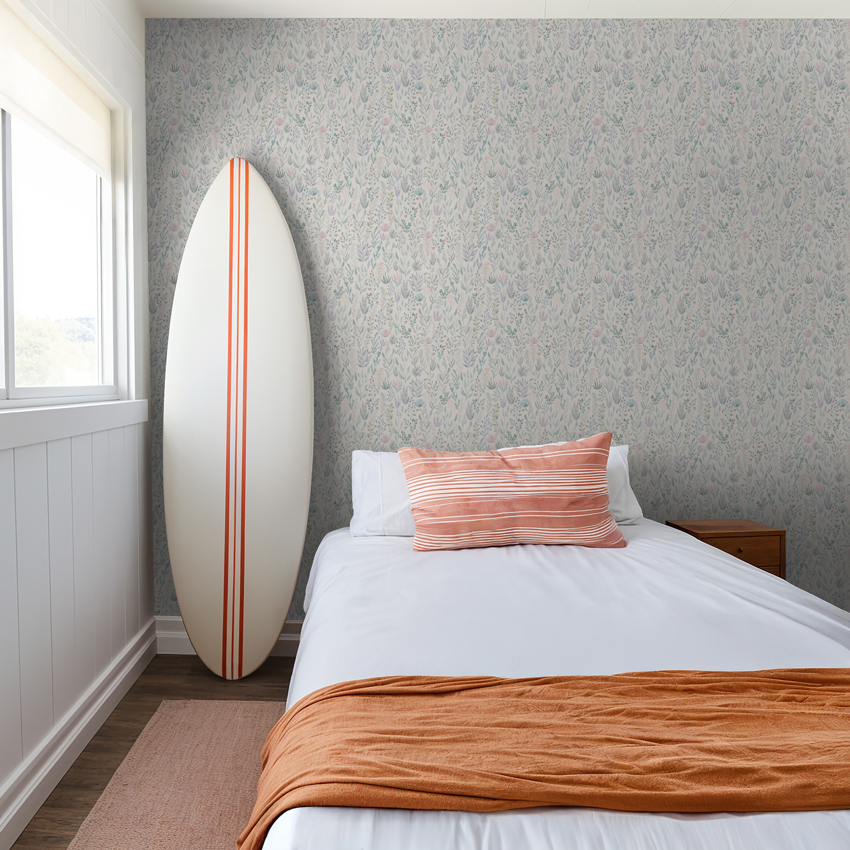 Bedroom with soft green floral wallpaper and surfboard decor.