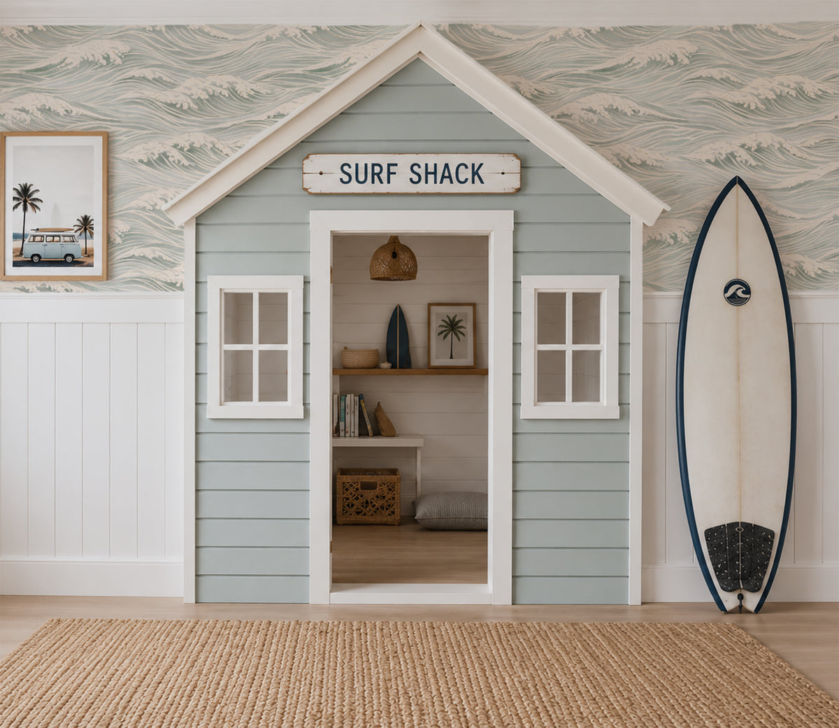 The Waves ocean wallpaper in soft blue and ivory above a coastal Surf Shack playhouse with surfboard decor.