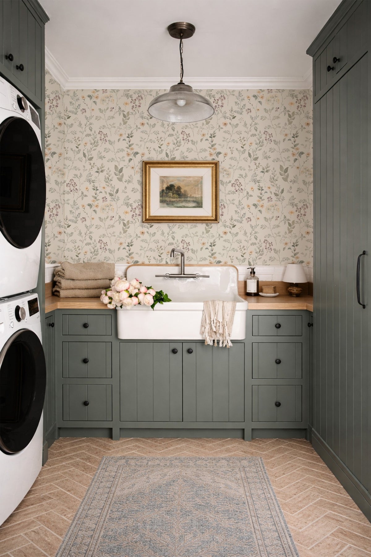 The Wildflower Way wildflower wallpaper in a vintage laundry room with green cabinetry and farmhouse sink