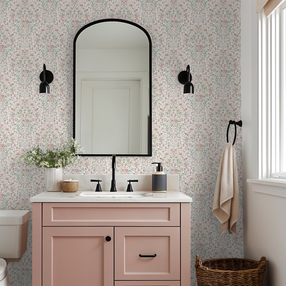 Powder bathroom with vintage floral wallpaper, blush vanity, and matte black fixtures.