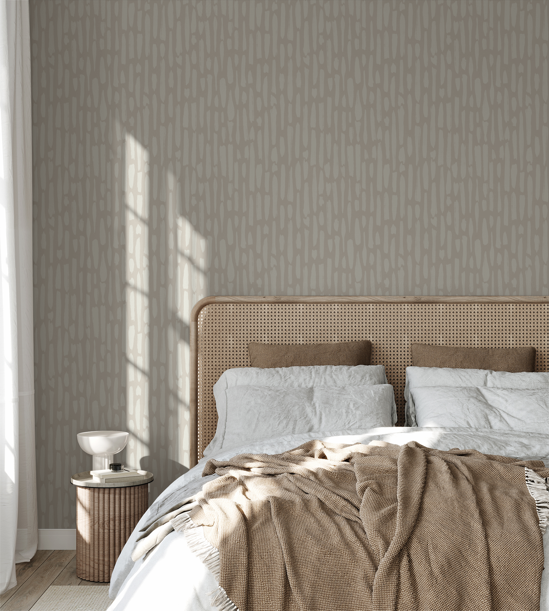 Neutral brushstroke wallpaper in cozy bedroom with rattan headboard and soft bedding